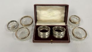 A GROUP OF VINTAGE GLASS SILVER RIMMED SALTS + A CASED PAIR OF SILVER NAPKIN RINGS,