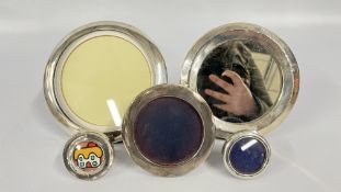 A GROUP OF FOUR CIRCULAR SILVER PHOTO FRAMES + A FURTHER WHITE METAL EXAMPLE,