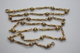 A 9CT GOLD NECKLACE OF RIVEN BATTON AND BALL DESIGN, LENGTH 58CM.