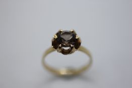 A 9CT GOLD DRESS RING SET WITH SMOKY QUARTZ.