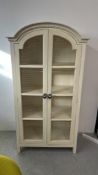 MODERN CONTINENTAL DESIGN TWO DOOR CAGED FRONT SHELVED CABINET, W 105 X D 54 X H 197CM.