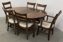 A GOOD QUALITY MODERN CIRCULAR EXTENDING DINING TABLE WITH LEAF ALONG WITH A SET OF SIX DINING