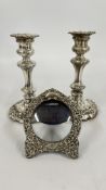 A PAIR OF ORNATE SILVER CANDLESTICKS WORN, (FILLED),