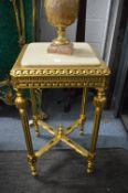 A gilt wood stand with marble top.