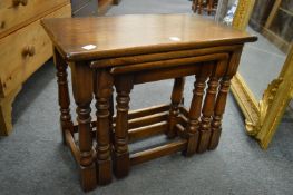 A nest of three oak tables.