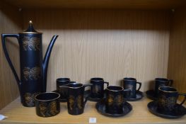 A Portmeirion coffee service, black ground decorated with a gilt lion.