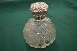 A cut glass and silver mounted perfume bottle.