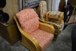 Two bamboo conservatory chairs, one with a stool.
