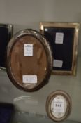 Three silver photograph frames.