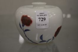 A small Chinese vase decorated with flowers.
