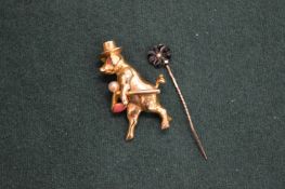 Decorative brooch modelled as a pig wearing a top hat holding a cane together with a tie pin.