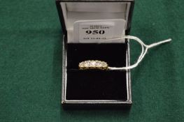 A gold and diamond five stone ring.