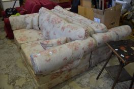 A pair of two seater settee's with floral upholstery.