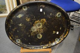 A Victorian oval papier mache tray with floral and gilt decoration.