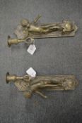 A pair of cast metal figural wall appliques.