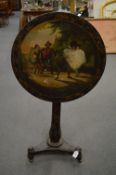 A Victorian papier mache and gilt decorated tilt-top circular tripod table, the top painted with