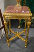A gilt wood stand with marble top.