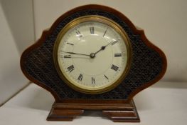 A small mahogany mantel clock.