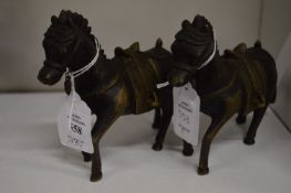 A pair of cast bronze horses.