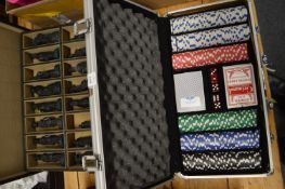 Poker set and a case containing chess pieces.