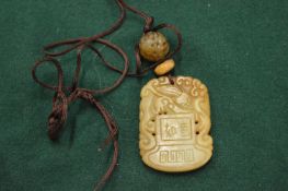 A Chinese carved jade amulet.