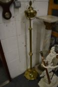 A brass telescopic stand lamp.
