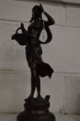Bronze figure of a young lady holding a basket.