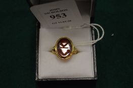 A gold and intaglio set signet ring.