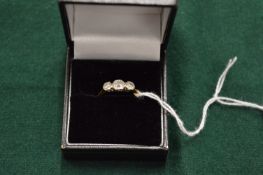 An 18ct gold and platinum three stone diamond ring.