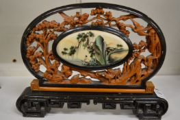A Chinese carved wood table screen.