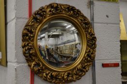 A gilt framed convex mirror.