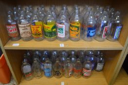 A quantity of old advertising milk bottles.