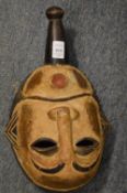 A carved and painted African wood mask.