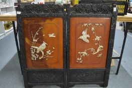 A Japanese folding screen with applied decoration depicting birds amongst branches.