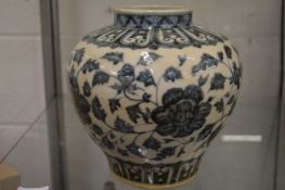 A large Chinese blue and white jar decorated with flowers.