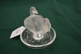 A Lalique pin tray mounted with a pair of frosted glass swans.