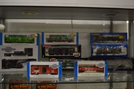 A quantity of boxed OO gauge trains and carriages etc.
