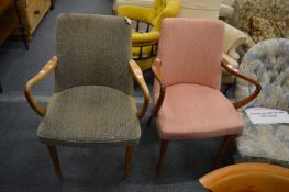 A pair of teak framed armchairs.