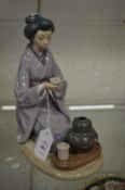 Lladro group of a seated Japanese female figure.