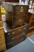 A military style brass bound three drawer chest and matching two drawer chest.