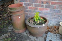 A large terracotta plant pot and a terracotta chimney pot.
