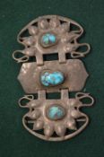Liberty & Co., a hammered silver belt buckle set with three turquoise cabochon stones.