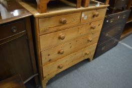 A pine chest of drawers.