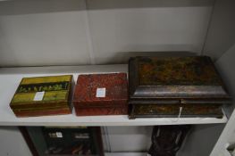 A 19th century chinoiserie decorated lacquer casket and cover and two other boxes.
