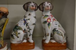 A pair of reproduction Chinese porcelain models of seated dogs.
