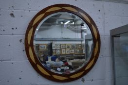 A stylish circular wall mirror.