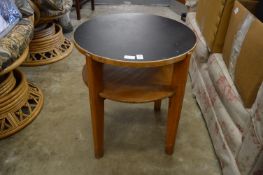 Moss Partners, an oak and black lacquer circular two-tier table.