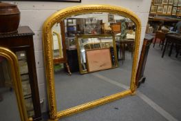 A large decorative Victorian style gilt framed over mantel mirror.