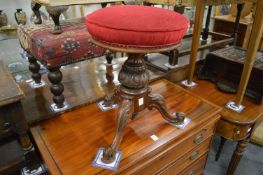 A Victorian carved walnut music seat.