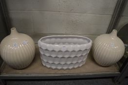 A pair of ribbed porcelain vases and another vase.